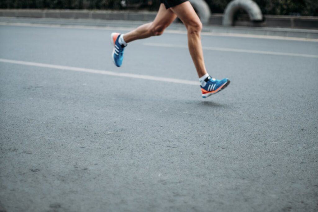 elderly woman running marathon finish line